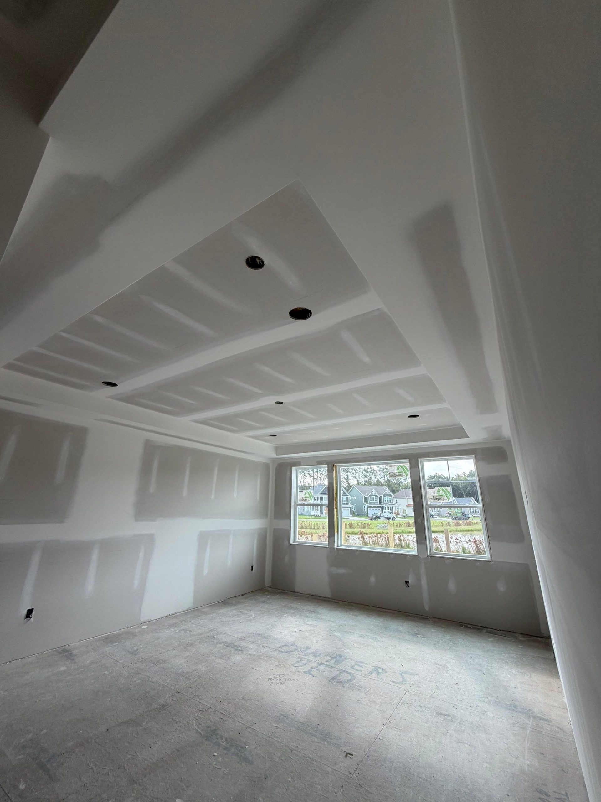 Finished hospitality corridor with smooth white drywall